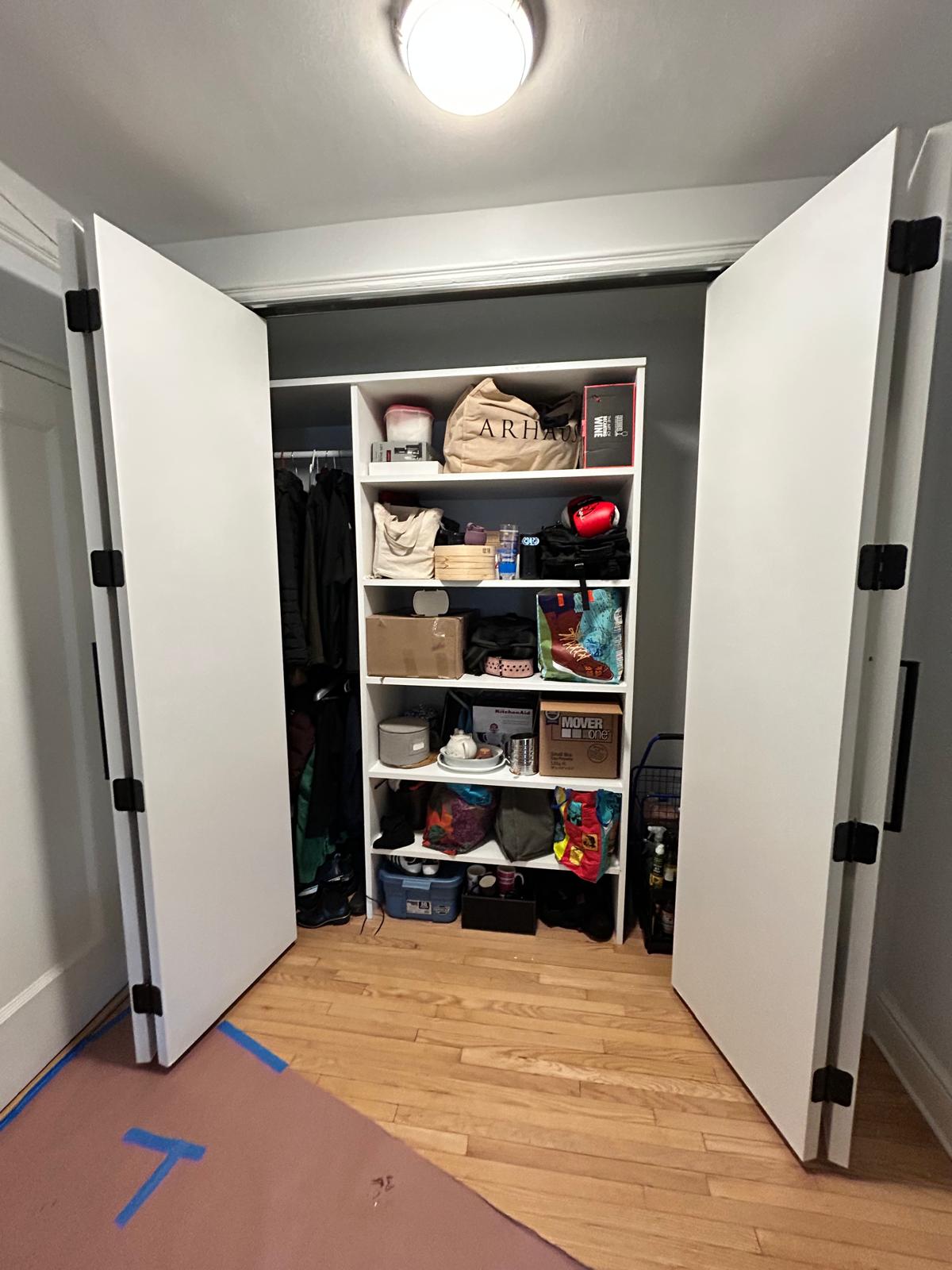 Finished entry closet — floor-to-ceiling built-in with double hanging rod and open shelving